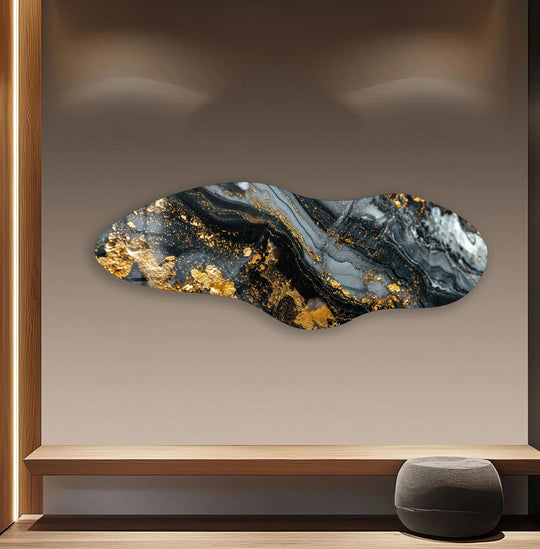 Minimalist beige wall highlights a striking abstract gold marble glass wall art decor piece with a fluid, irregular shape.