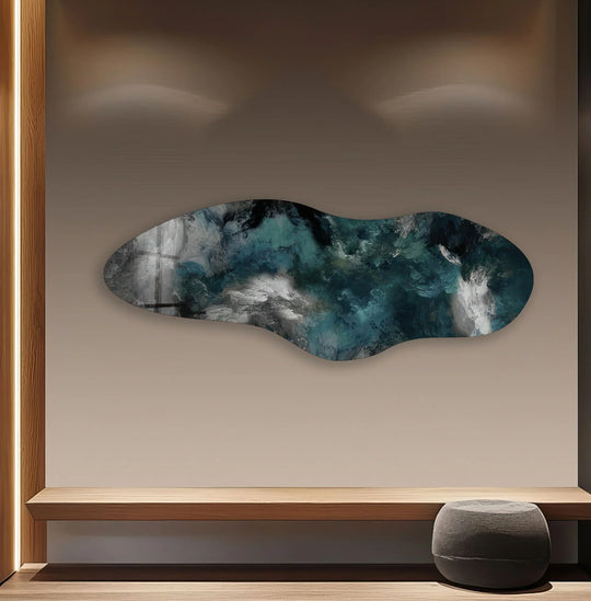 Turbulent waves of teal and white swirl with dynamic motion across this striking asymmetric glass wall art, a captivating piece of home decor.