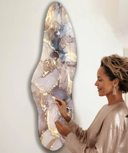A woman in a sparkly dress adjusts an abstract marble glass wall art decor against a plain white background.