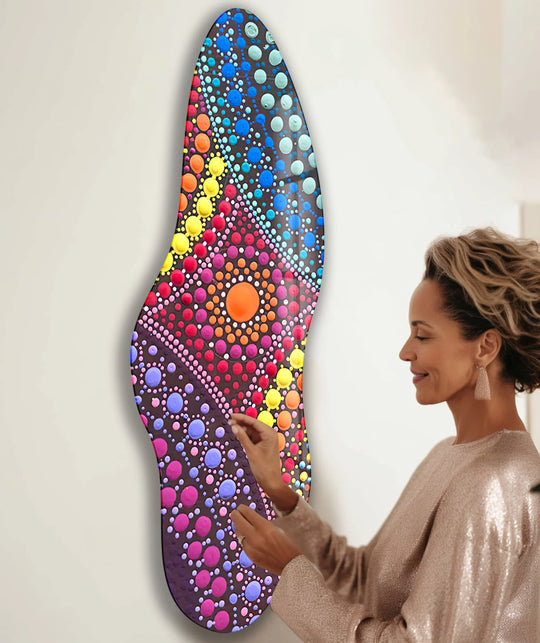 Woman admiring a vibrant, irregular pink mosaic decorative glass wall art, a striking piece of home decor.