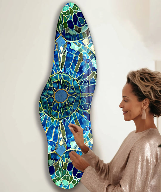 A woman admires a bright mosaic navy blue irregular glass wall art with intricate details from glass printing.