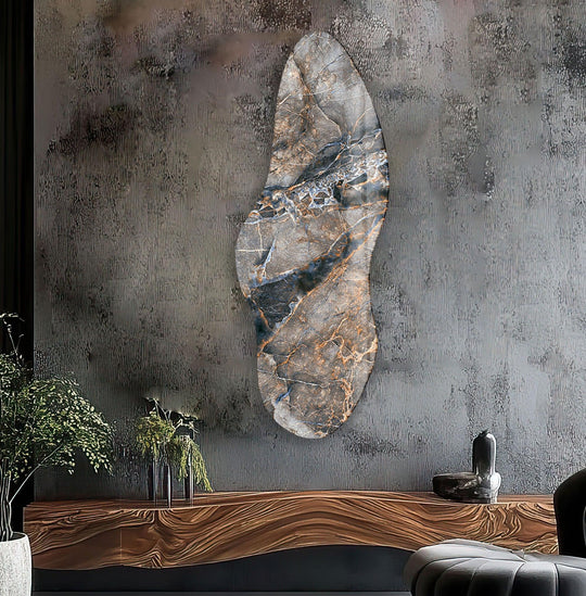 Irregular asymmetrical brown abstract glass wall art featuring a central stone-like design against a textured gray background, making it the loudest element.