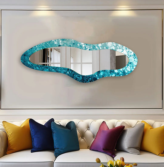 Transitional teal and turquoise hues create a striking color gradient effect in this blue irregular shape glass wall mirror, a piece of modern mirror adding artistic flair.