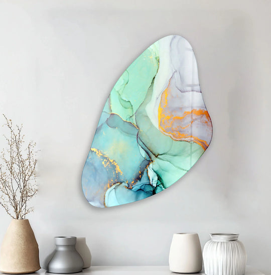 The interplay of light and shadow across this asymmetrical turquoise watercolor glass wall art reveals ethereal washes of color and subtle gold highlights.