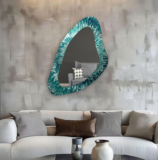 Reflecting the subdued room, the darkest area of the modern green line asymmetrical decorative mirror reveals a glimpse of seating within its unique design.