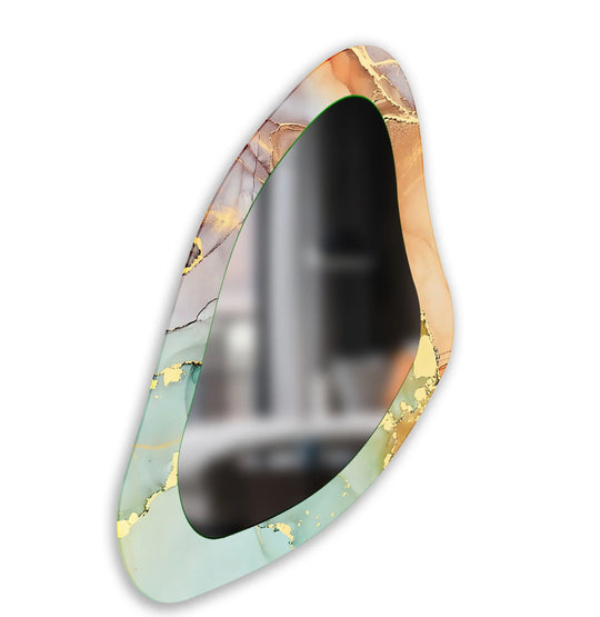 An asymmetric mirror displays an irregular abstract design with light green and gold tones ideal for glass wall art