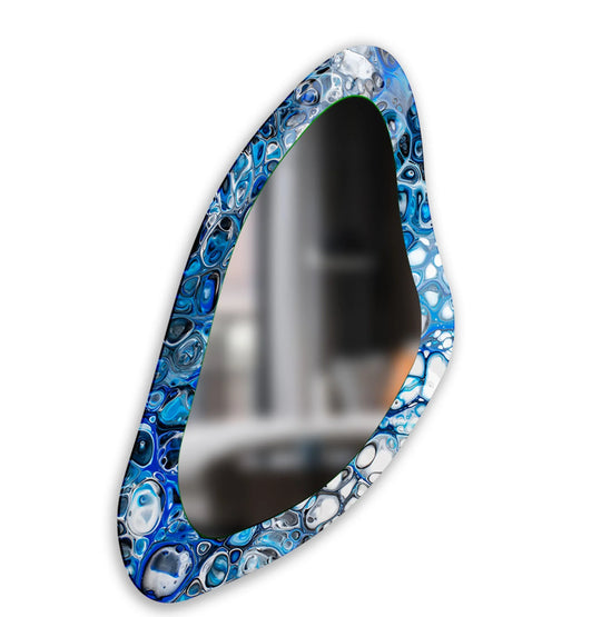 Swirling blue watercolor in an asymmetric wall mirror gives a dynamic sense of motion, perfect for decorating with wall mirrors and adding a modern touch.