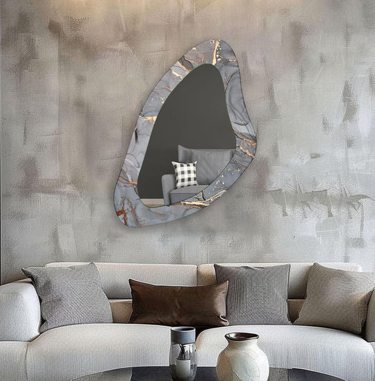 An asymmetric mirror with a grey abstract and gold fluid design an elegant glass wall mirror reflecting a modern living room