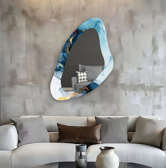 Brightest area highlights the artistic, light blue watercolor patterns adorning this asymmetric decorative wall mirror, a stunning example of modern wall mirrors reflecting style.