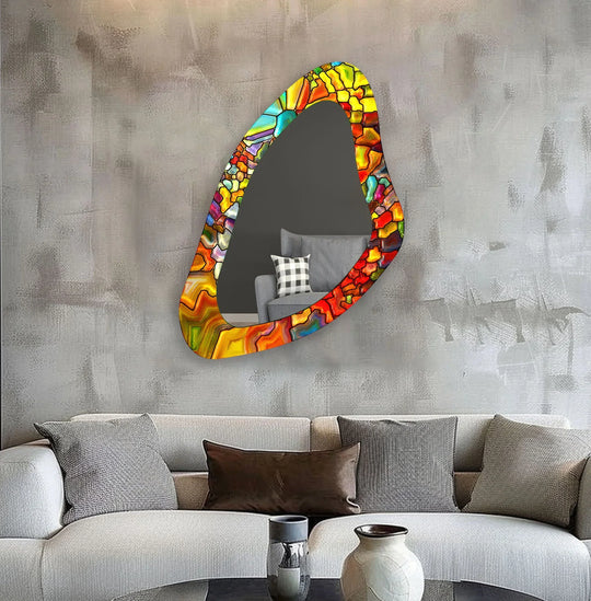 Striking color contrast accentuates the orange stained asymmetrical wall mirror and its unique shape as a modern mirror above the neutral couch.