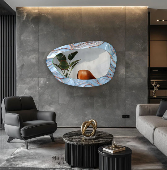 Asymmetric glass wall mirror with a blue and white wavy pattern and copper lines reflecting a plant an artistic abstract mirror design