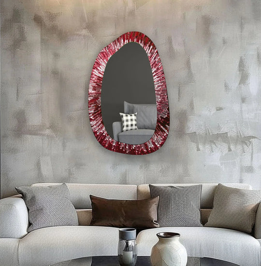 Red Abstract Glass Wall Mirror with a vibrant red and white asymmetric design an irregular piece reflecting a gray couch