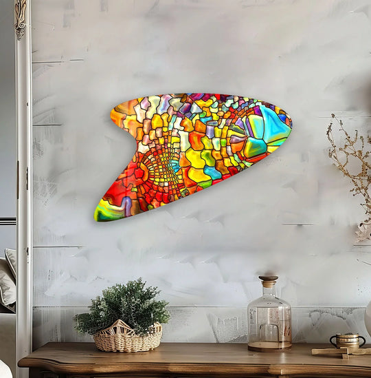 A vibrant, irregular glass wall artwork features the brightest hues of sapphire and golden yellow in its abstract mosaic design.
