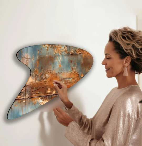 A woman in a sparkly dress admires the flowing visual rhythm of this abstract print wall art featuring rust and blue textures.