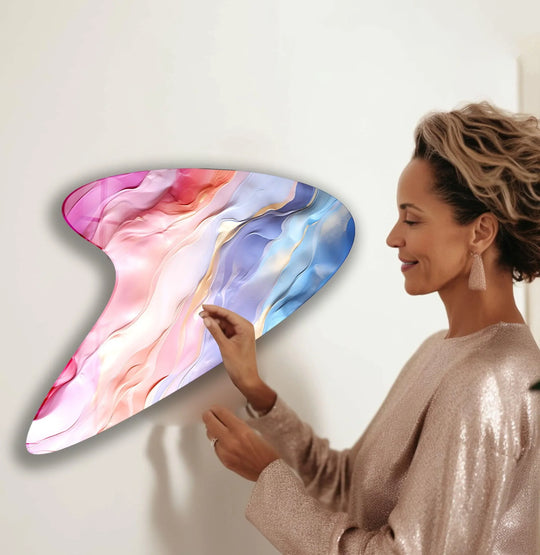 A smiling woman admires a modern pink abstract glass wall art print, creating a feeling of refined elegance.