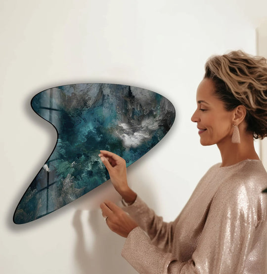 Dominant colors of deep teal and emerald green swirl across this irregular glass wall artwork.