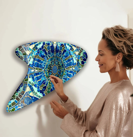A woman touches a mosaic of vibrant blues and teals in this decorative wall art, showcasing a stunning color transition.