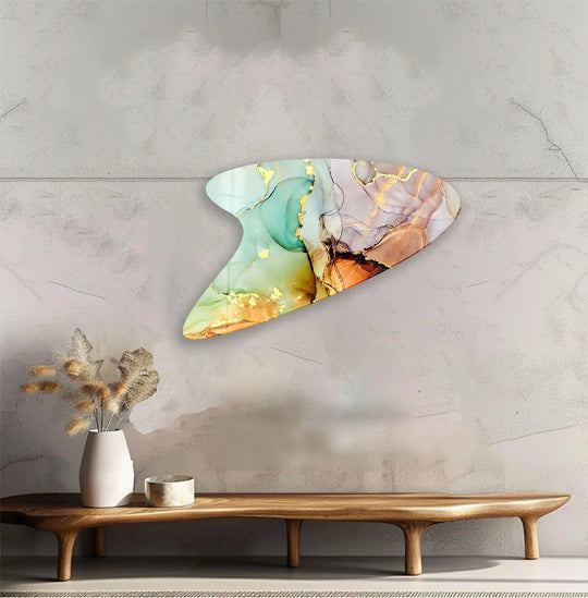 Irregularly shaped art from glass with shimmering gold veins and softly blended emerald, peach, and violet hues, showcasing a smooth, polished edge.