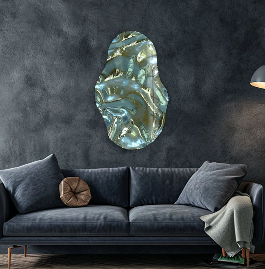 Dominant dark grey tones surround a uniquely shaped glass art painting with metallic green and blue abstract waves.