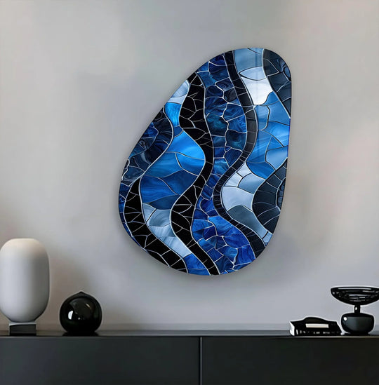 A cool-toned abstract glass wall art featuring a mosaic of sapphire and icy blue glass pieces.