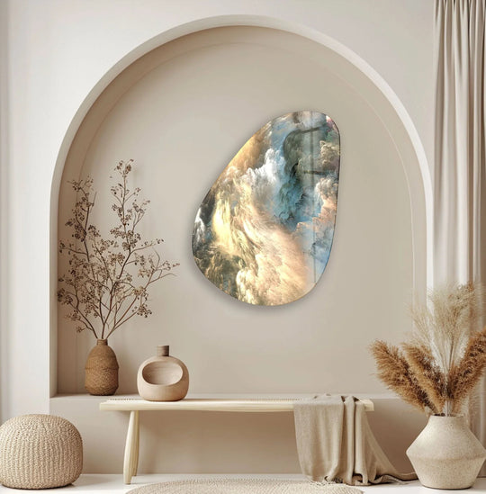 An abstract glass art piece hangs in an arched niche above a wooden bench, featuring dried florals and pampas grass.