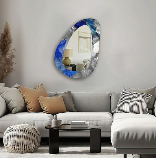 With striking color saturation, this asymmetrical mirror for wall decor showcases a blue abstract design, reflecting light and adding visual interest to the space.