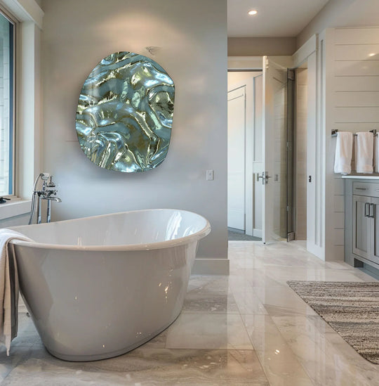 A mesmerizing oval abstract glass wall art features a unique modern wall decor finish in swirling shades of metallic green and silver.