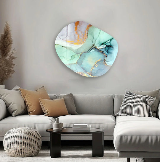 A pale gray wall serves as the backdrop for a captivating turquoise asymmetrical oval glass wall art, offering sophisticated home decor.