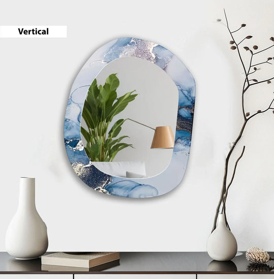 An asymmetric mirror made of glass features a blue and white abstract design and vertical orientation a modern entryway wall mirror