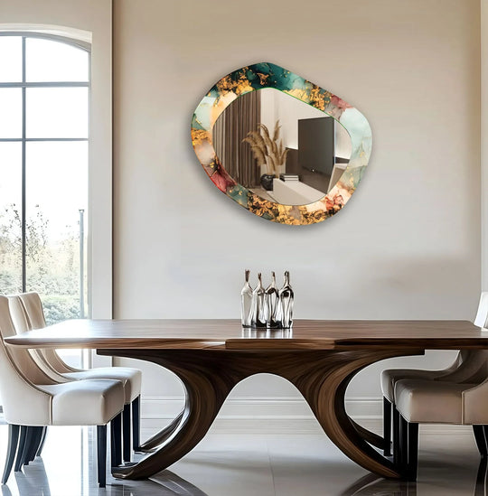 An asymmetric wall mirror with a color abstract motif shimmering gold accents and tempered glass