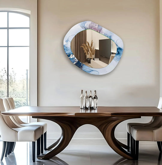An asymmetric mirror with a blue and white abstract design a modern entryway wall mirror reflecting a stylish interior