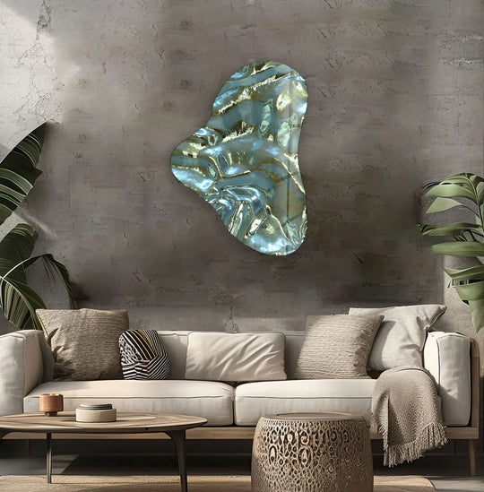 Asymmetrical metal artwork creates visual rhythm with flowing metallic green glass shapes on a textured wall.