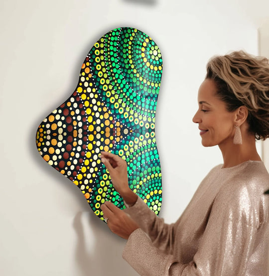 A woman admires green mosaic glass wall art, highlighting the vibrant transition from yellow to deep green hues.