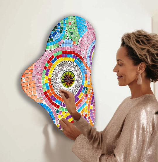 A woman gazes at a vibrant, colorful mosaic glass printing, creating a joyful and artistic mood.