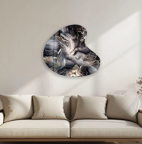 Swirling golden watercolor abstract wall art prints flow dynamically across the irregular glass surface.