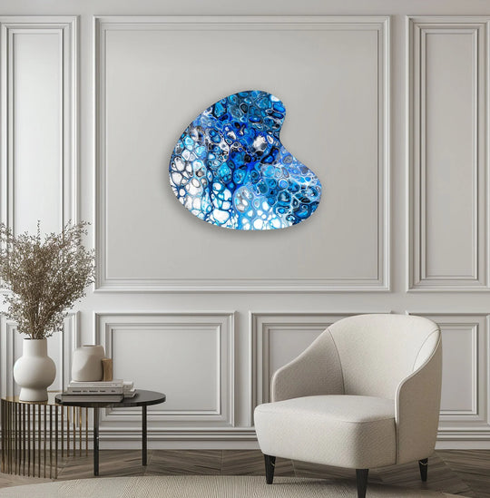 Bold, abstract navy blue and white cells of hanging wall art shimmer vibrantly.