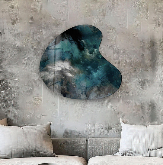 Dark, deep sapphire blues and black hues swirl within the abstract irregular glass wall artwork, evoking a stormy, ethereal atmosphere.