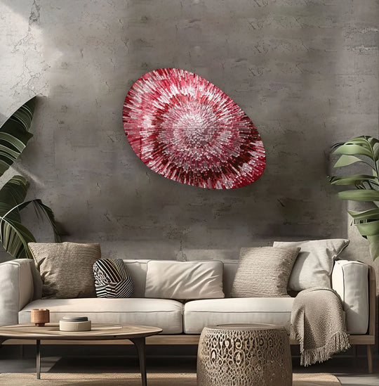 A dark, textured concrete wall serves as a backdrop for a striking, unique modern wall decor, featuring a red abstract spiral oval glass art piece.