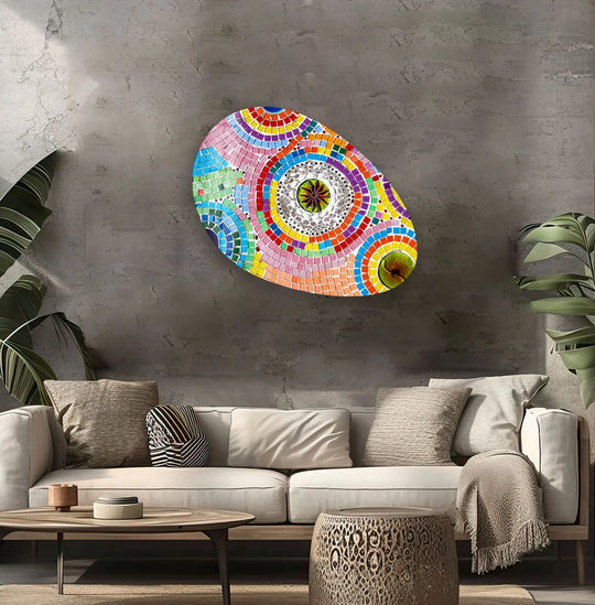 An abstract glass printing artwork showcases a kaleidoscope of organic circular forms in vibrant pinks, blues, and yellows.