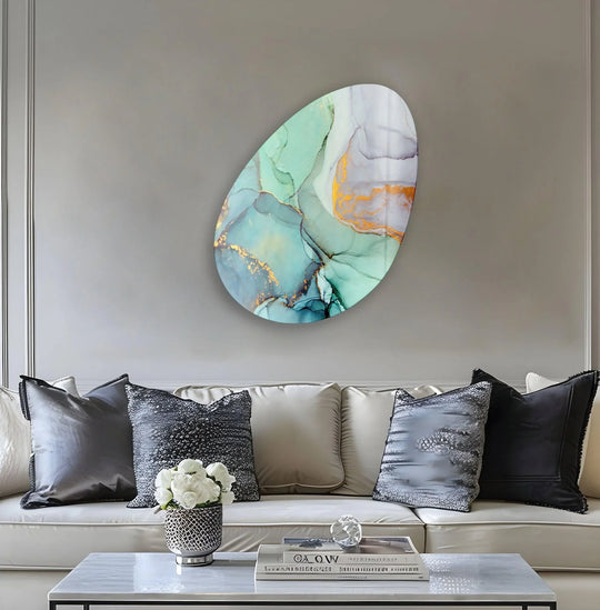 A tranquil oval glass wall art with mesmerizing layers of turquoise and gold alcohol ink, creating a sense of depth.