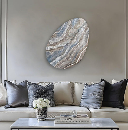 A modern blue marble oval glass art piece with intricate swirling patterns is displayed on a coffee table.