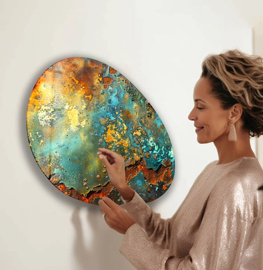 Oval glass wall art with a textured, rusty, and blue-green finish, perfect for glass printing.