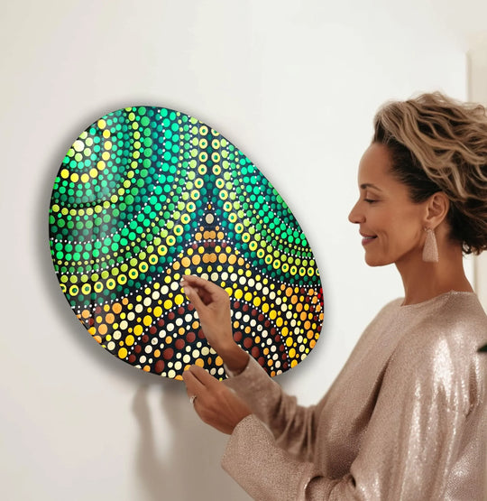 A woman adjusts a vibrant abstract hanging wall art with a stunning green to yellow color transition.