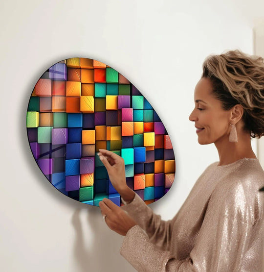 A woman admires vibrant, brightly lit abstract glass art featuring a colorful geometric pattern.