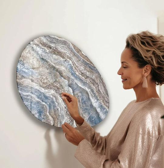 A woman admiring a unique modern wall decor piece with a serene, contemplative mood.