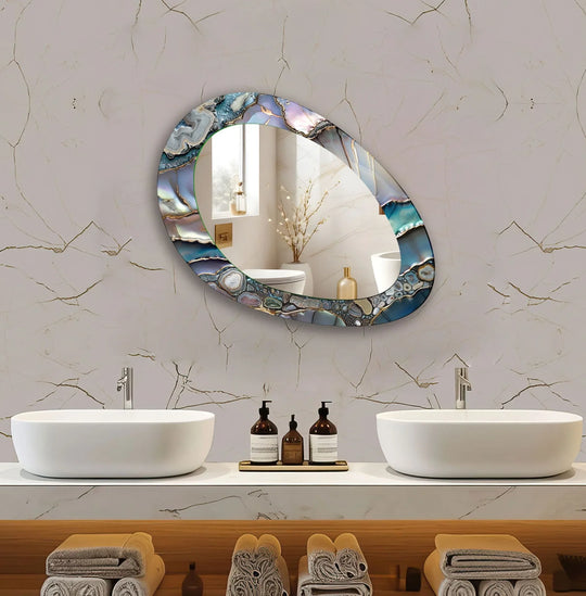 Asymmetric mirror with a gray metallic abstract design in blue purple and grey tones reflecting a unique modern bathroom