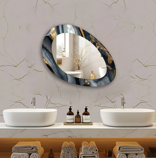 An asymmetric mirror featuring a luxurious gold and black abstract design enhancing a modern bathroom wall above sinks