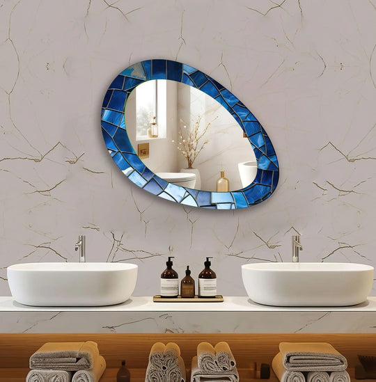 The blue stained oval asymmetric mirror features a stained glass design and is a decorative wall mirror making it a stunning glass wall art wall mirror addition