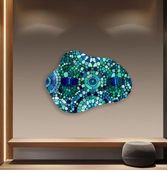 Dark navy mosaic glass art features irregular shapes and varying shades of green and blue.