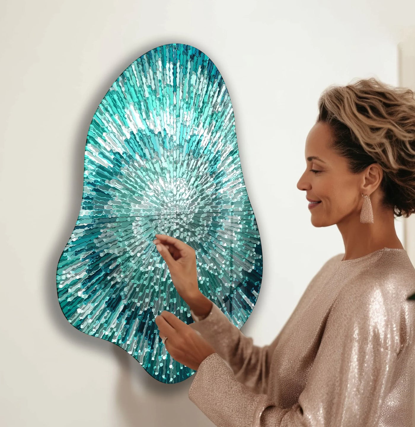 An asymmetric abstract turquoise helix glass art piece with a spiral shape hangs on a wall.